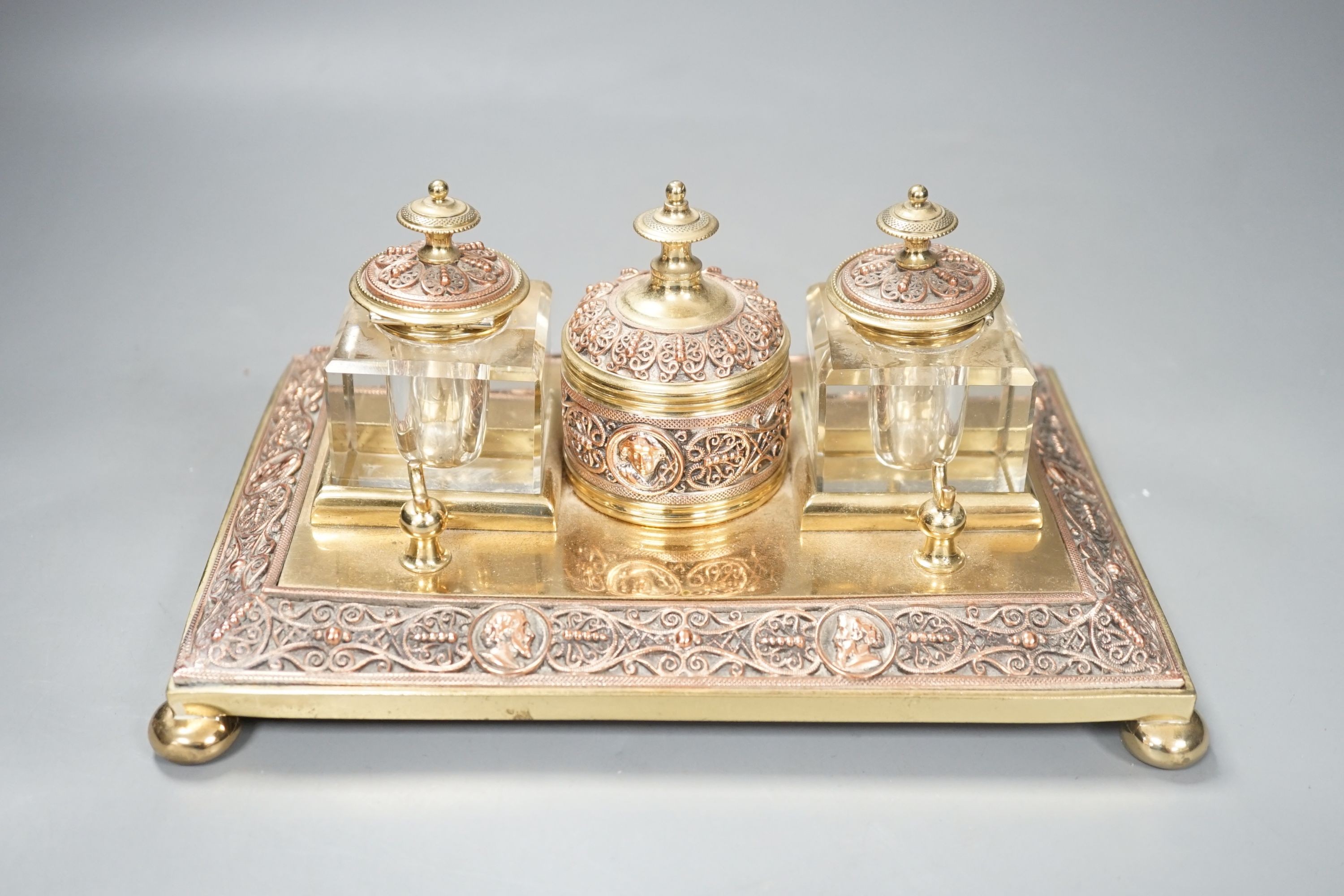 A 19th century copper and brass two bottle inkstand. Length 24cm